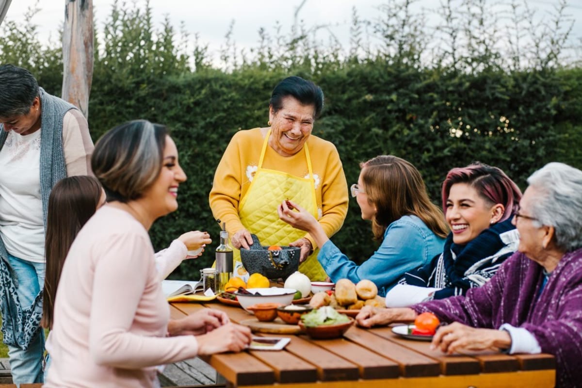 A happy family enjoying a meal together outdoors